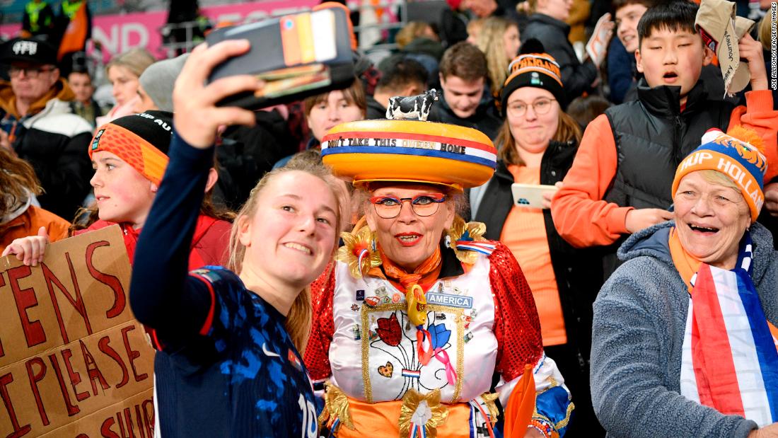 Dutch midfielder Wieke Kaptein takes a selfie with fans after the Netherlands defeated Vietnam 7-0 and advanced to the knockout stage.