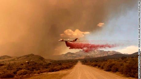 A tanker makes a fire retardant drop over the York Fire in Mojave National Preserve on Saturday.