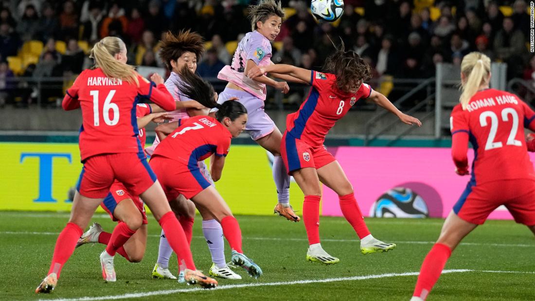Japan&#39;s Mina Tanaka, center, rises for a header against Norway.