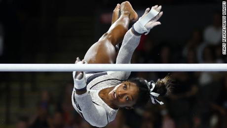 Simone Biles competes in the uneven bars during the Core Hydration Classic.