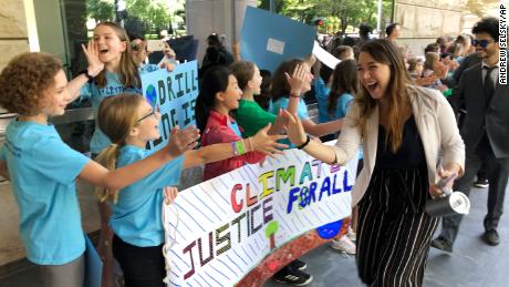 Kelsey Juliana of Eugene, Oregon, one of Juliana&#39;s lead plaintiffs, greets supporters outside a federal courthouse in Portland in 2019.
