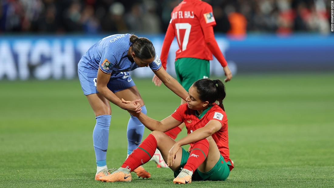 Morocco&#39;s Sakina Ouzraoui is consoled by France&#39;s Estelle Cascarino after the match.