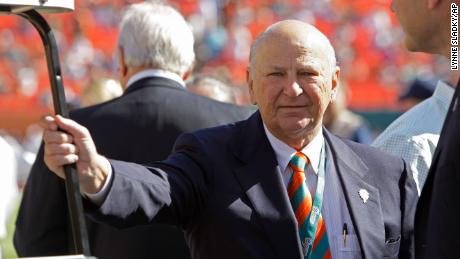 In this 2012 photo, H. Wayne Huizenga stands on the field before an NFL football game between the Miami Dolphins and New York Jets in Miami.