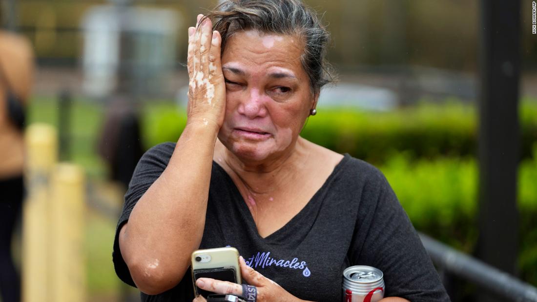 Myrna Ah Hee reacts as she waits in front of an evacuation center in Wailuku on August 10. The Ah Hees were looking for her husband&#39;s brother. Their home in Lahaina was spared, but the homes of many of their relatives were destroyed by wildfires.