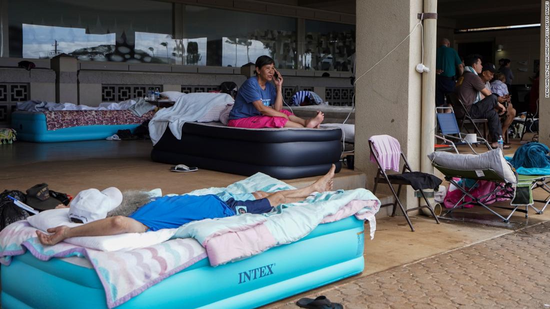 Puong Sui, center, talks to her daughter at the evacuation center in Kahului on August 10. Sui lost her house and belongings in Lahaina and was planning to fly to Las Vegas to reunite with her family.