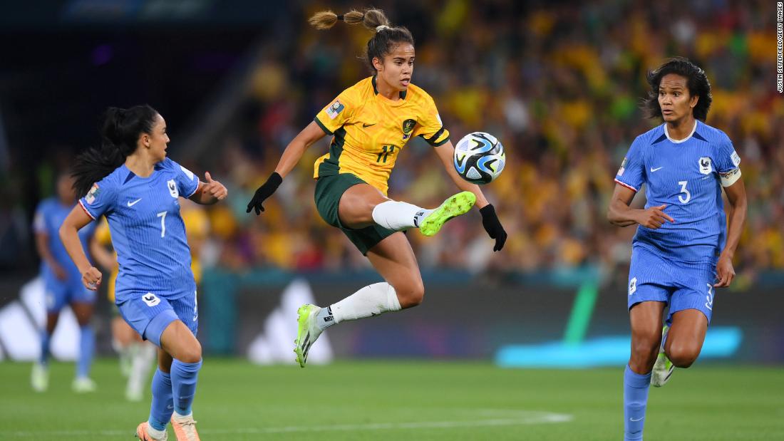 Australia&#39;s Mary Fowler controls the ball between France&#39;s Sakina Karchaoui and Wendie Renard.