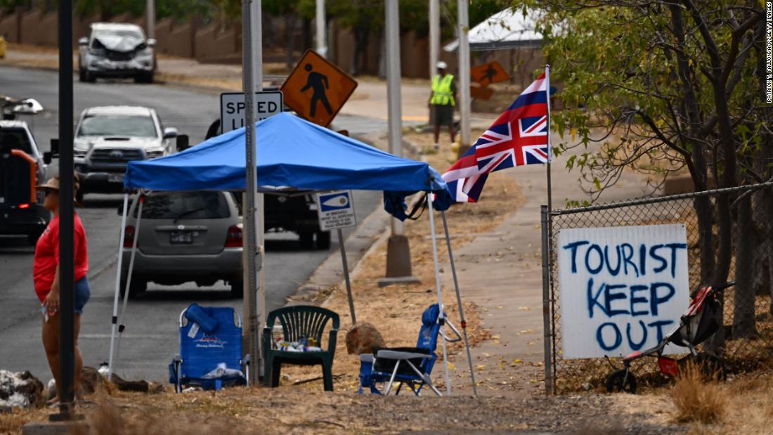 The state flag of Hawaii flies over a sign in Lahaina that says &quot;tourist keep out&quot; on August 16. &lt;a href=&quot;https://www.cnn.com/videos/world/2023/08/17/exp-maui-tourists-wildfires-lee-intvw-081712aseg2-us.cnn&quot; target=&quot;_blank&quot;&gt;Vacationers are being asked to stay home&lt;/a&gt; as Maui recovers. Many hotels are housing evacuees.