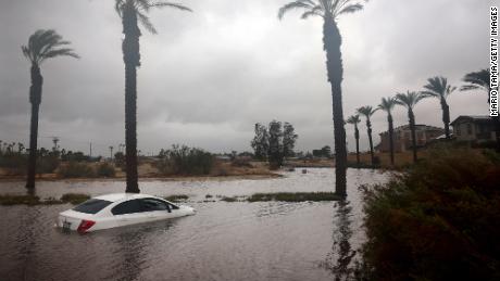 A car is partially submerged in floodwaters as Tropical Storm Hilary moves through the area on August 20, 2023 in Cathedral City, California. Southern California is under a first-ever tropical storm warning as Hilary impacts parts of California, Arizona and Nevada. All California state beaches have been closed in San Diego and Orange counties in preparation for the impacts from the storm which was downgraded from hurricane status. 
