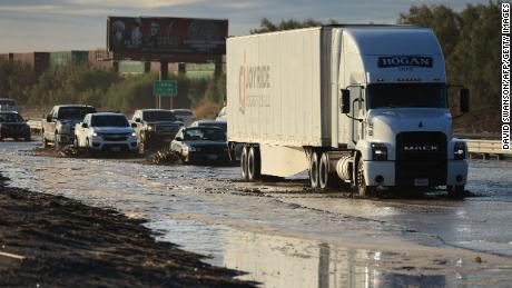 Traffic is slowed as water and mud from Tropical Storm Hilary covers part of Interstate 10, between Indio and Palm Springs, California, on Monday.
