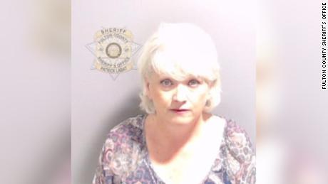 Former county GOP chair Cathy Latham, pictured in her booking photo, escorted visitors to the election office days after urging people to &quot;out-vote the fraud.&quot;