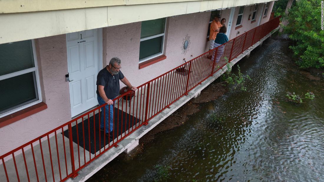 Ken Kruse looks out at floodwaters surrounding his apartment complex in Tarpon Springs, Florida, on August 30.