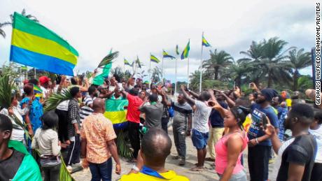 People celebrate in support of the military coup leaders in Libreville, Gabon on Wednesday.