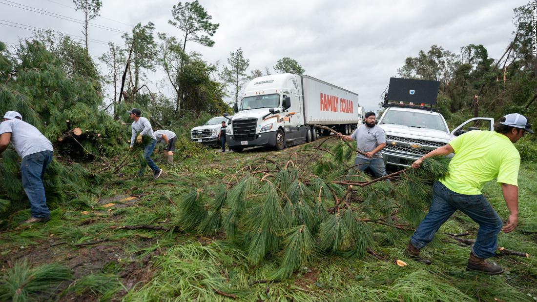 People work to clear I-10 of fallen trees near Madison, Florida, on August 30.