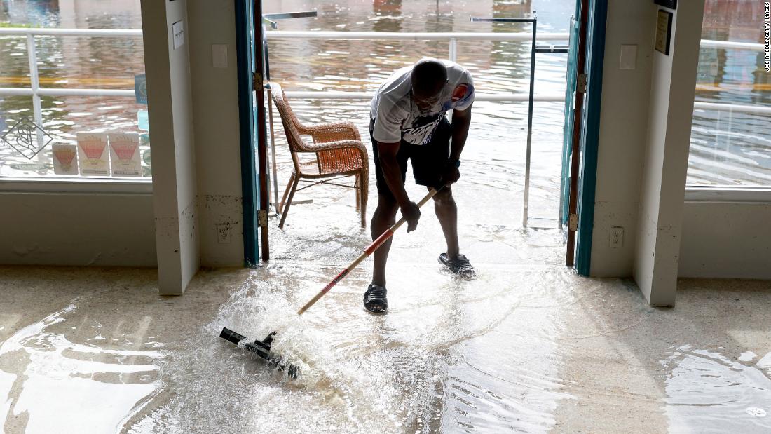 Donnye Franklin helps a friend try to get floodwaters out of his store in Crystal River, Florida, on August 30.