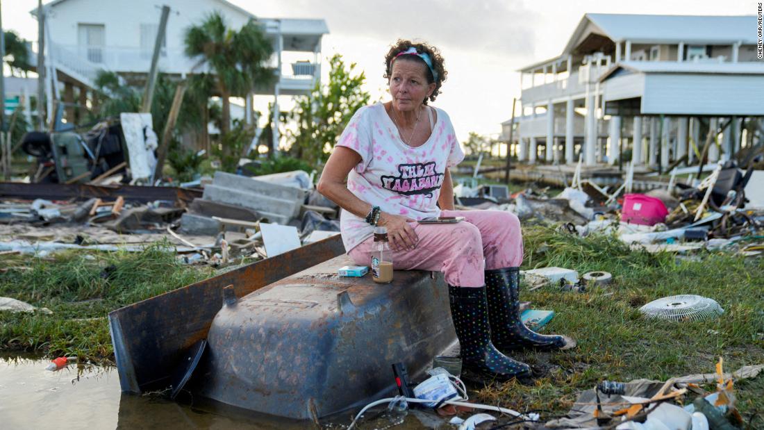 Jewell Baggett sits on a bathtub amid the wreckage of the home built by her grandfather, where she grew up and three generations of her family lived, in Horseshoe Beach on August 30.