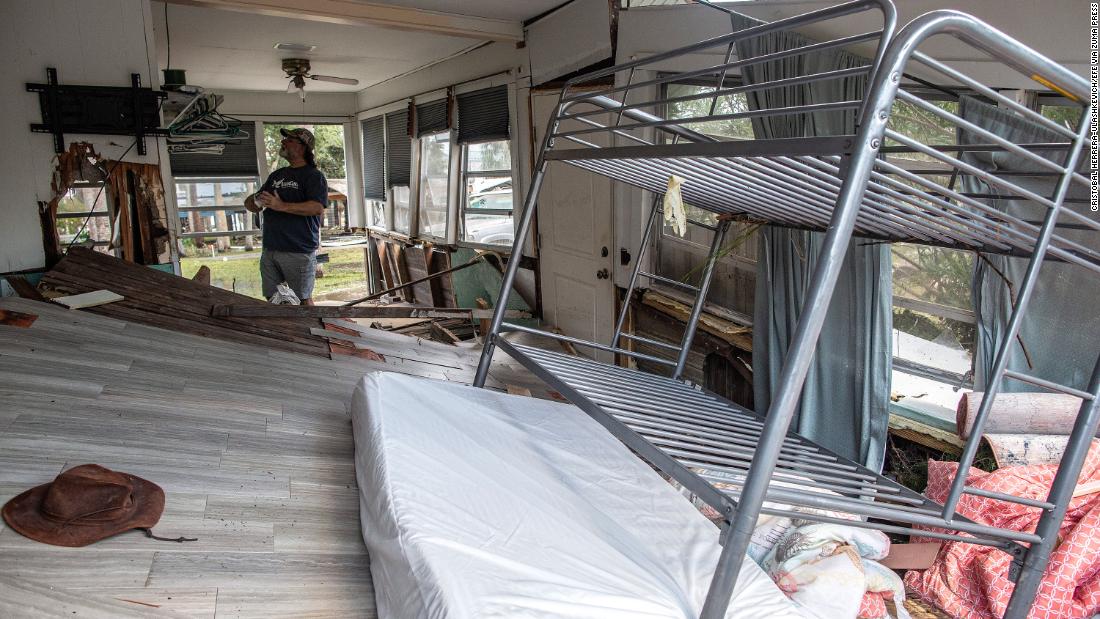 A person looks at the damage inside a destroyed house in Horseshoe Beach on August 30.