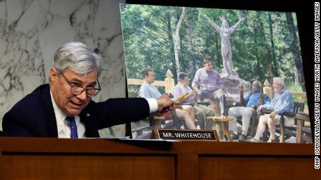 Senate Judiciary Committee member Sen. Sheldon Whitehouse displays a copy of a painting featuring Supreme Court Associate Justice Clarence Thomas alongside other conservative leaders during a hearing on Supreme Court ethics reform in the Hart Senate Office Building on Capitol Hill on May 02, 2023 in Washington, DC. 