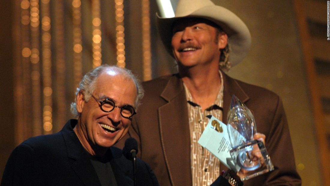 Buffett and Alan Jackson accept an award for their song &quot;It&#39;s 5 O&#39;Clock Somewhere&quot; at the 2003 Country Music Association Awards.