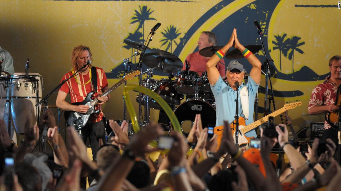 Buffett gives the &quot;fins up&quot; gesture while performing in 2009. 