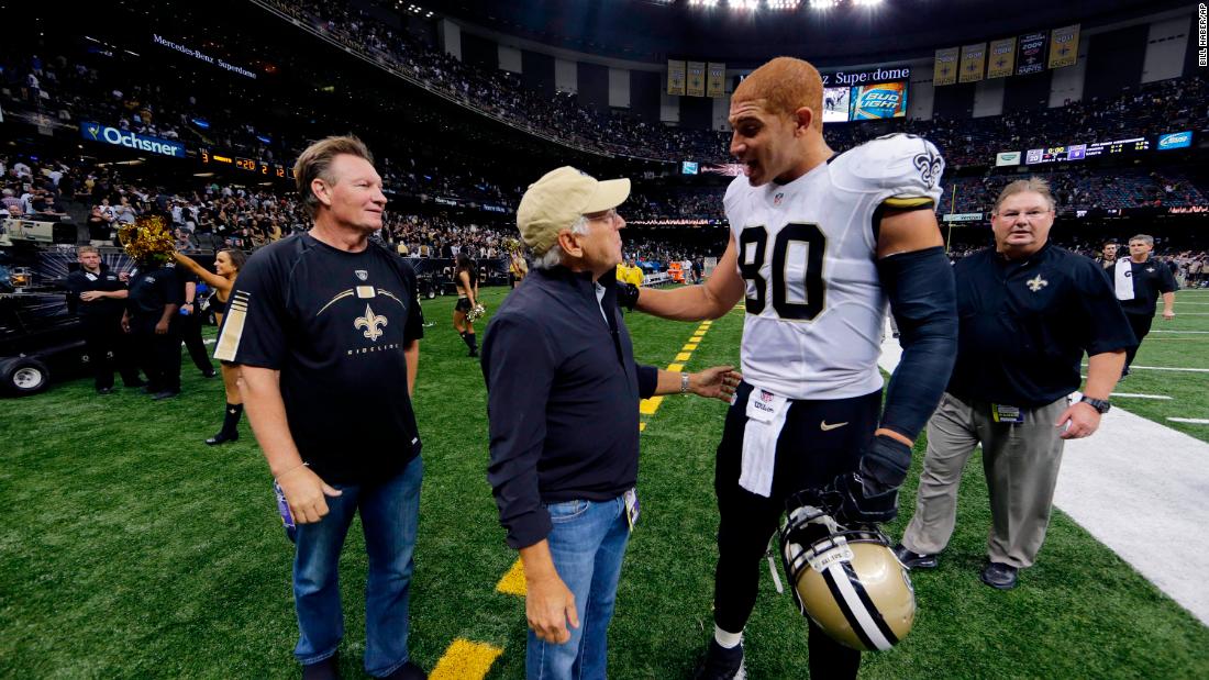 Buffett talks with New Orleans Saints tight end Jimmy Graham after an NFL game against the Minnesota Vikings in 2014. According to a FOX 8 interview, Buffett was a Saints fan &quot;since day one.&quot;