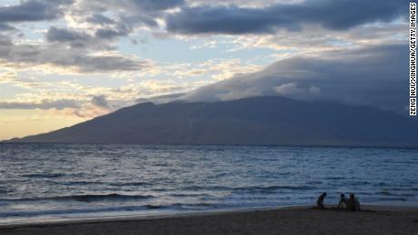 Photo taken on Aug. 21, 2023 shows people spending time on an empty beach in Maui, Hawaii, the United States. The devastating wildfires that ravaged the Hawaiian island of Maui were a bitter blow to the island&#39;s tourism industry, but local residents and business leaders expect more tourists will come back as the island embarks on a long road ahead for recovery. (Photo by Zeng Hui/Xinhua via Getty Images) TO GO WITH Roundup: Wildfires shake tourism in Hawaii&#39;s Maui island