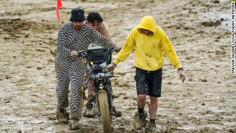 Burning Man organizers lift driving ban after heavy rains left the event smothered in mud and trapped thousands