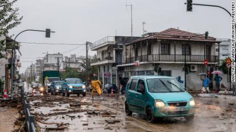 Cars drive among debris and mud, following a flash flood during a storm in the city of Volos, Greece, September 5, 2023. 