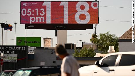 A billboard displays a temperature of 118 degrees Fahrenheit (48 degrees Celcius) during a record heat wave in Phoenix, Arizona, on July 18, 2023. 