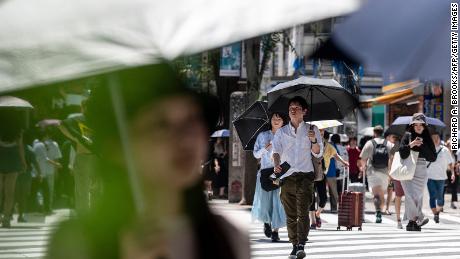 People seek relief from the heat in Tokyo, on July 30, 2023. Temperatures of 35 degrees Celsius (95F) and above scorched the Japanese capital for weeks.
