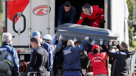 Funeral directors and forensic workers load bodies of victims into a refrigerated truck after an extratropical cyclone hit southern cities, in Mucum, Rio Grande do Sul, Brazil, September 6, 2023. 