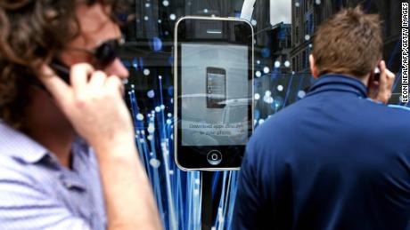Customers queue outside the Apple Store in London for the launch of the iPhone 3G on July 11, 2008. 