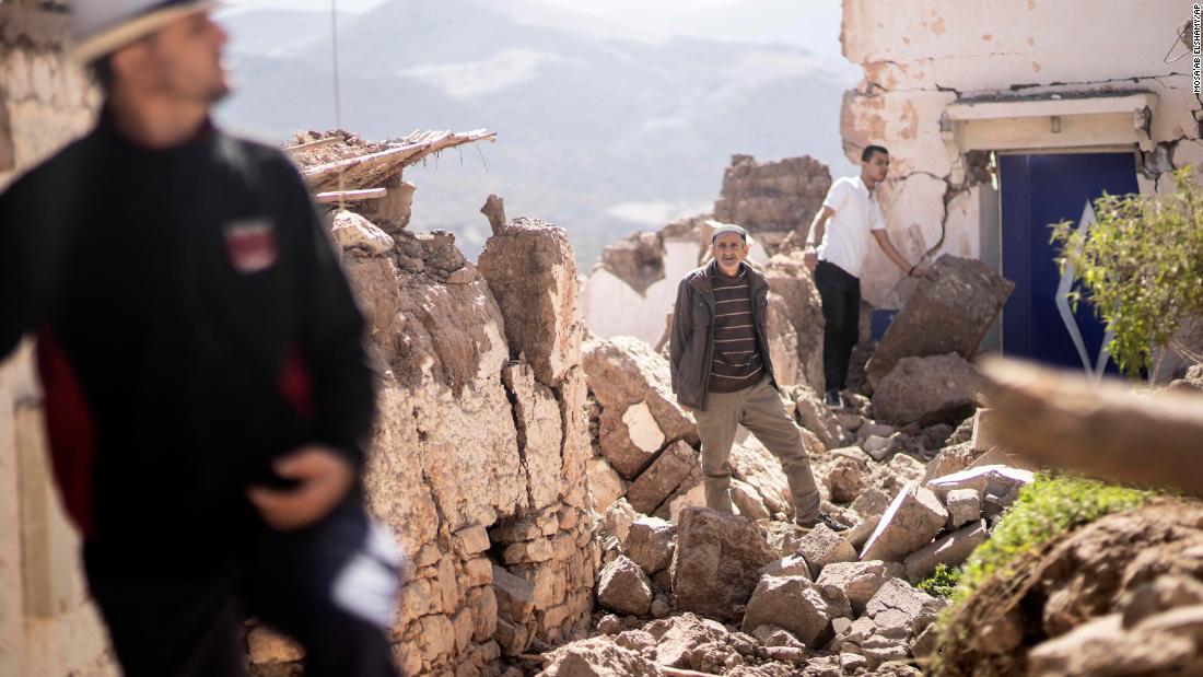 People inspect damaged homes in Moulay Brahim on September 9.