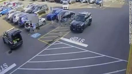 Video from a Kroger surveillance camera shows a black car parked in a handicap spot as officers arrive.