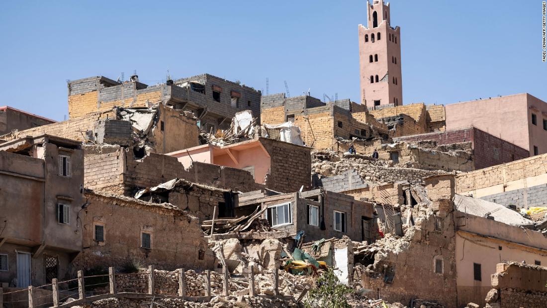 The minaret of a mosque stands behind damaged houses in Moulay Brahim on September 9.