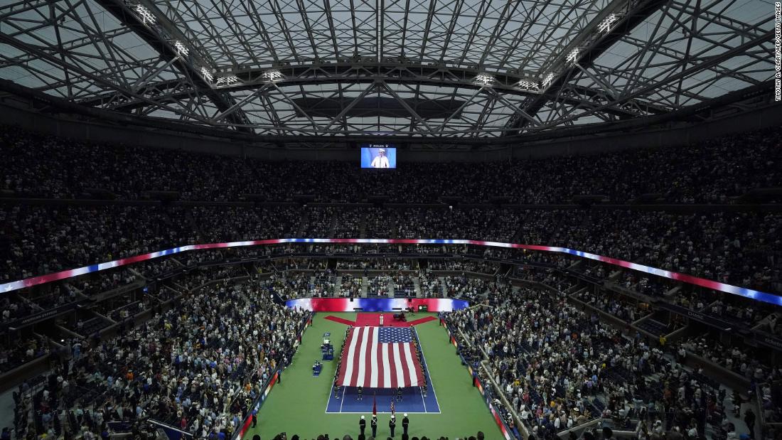 A US flag is unfurled during the opening ceremony for the US Open women&#39;s singles final.