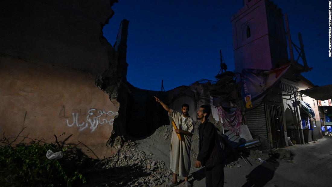 People inspect collapsed buildings in Marrakech on September 10.