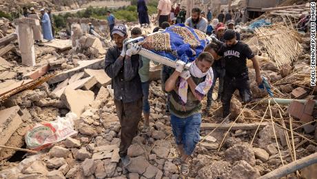 People carrying the remains of a victim, in the village of Imi N&#39;Tala.