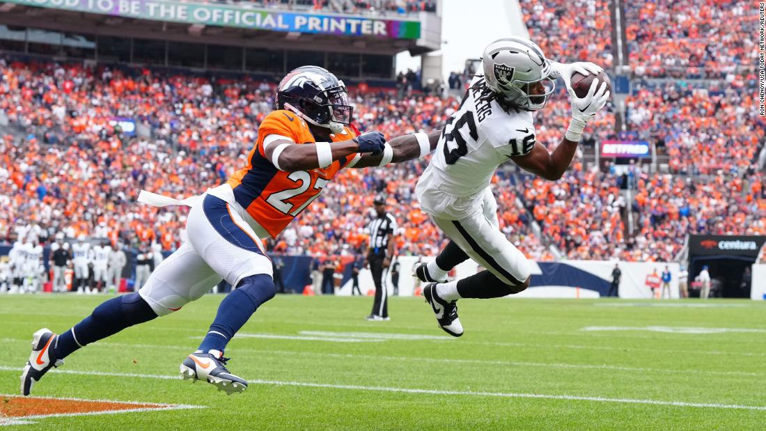 Las Vegas Raiders wide receiver Jakobi Meyers pulls in a touchdown past Denver Broncos cornerback Damarri Mathis in the first quarter at Empower Field at Mile High on September 10. The score would be important as the Raiders edged the home side, 17-16.