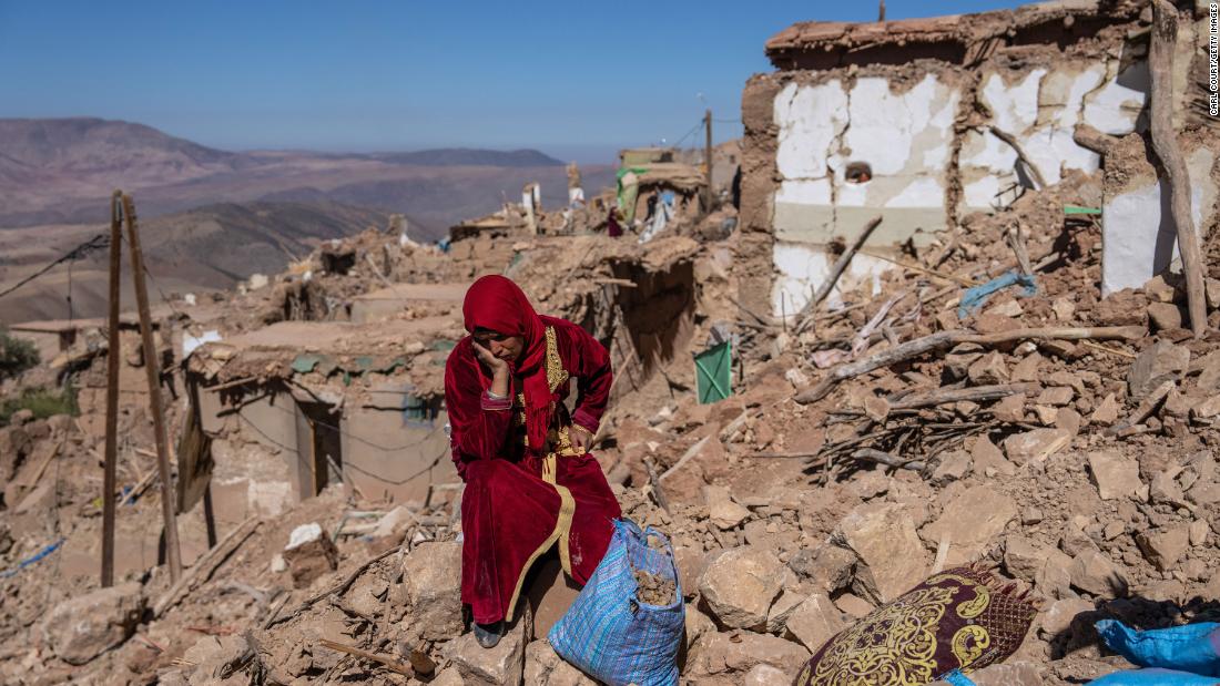 A woman sits amid the rubble in Douzrou, Morocco, on September 11.