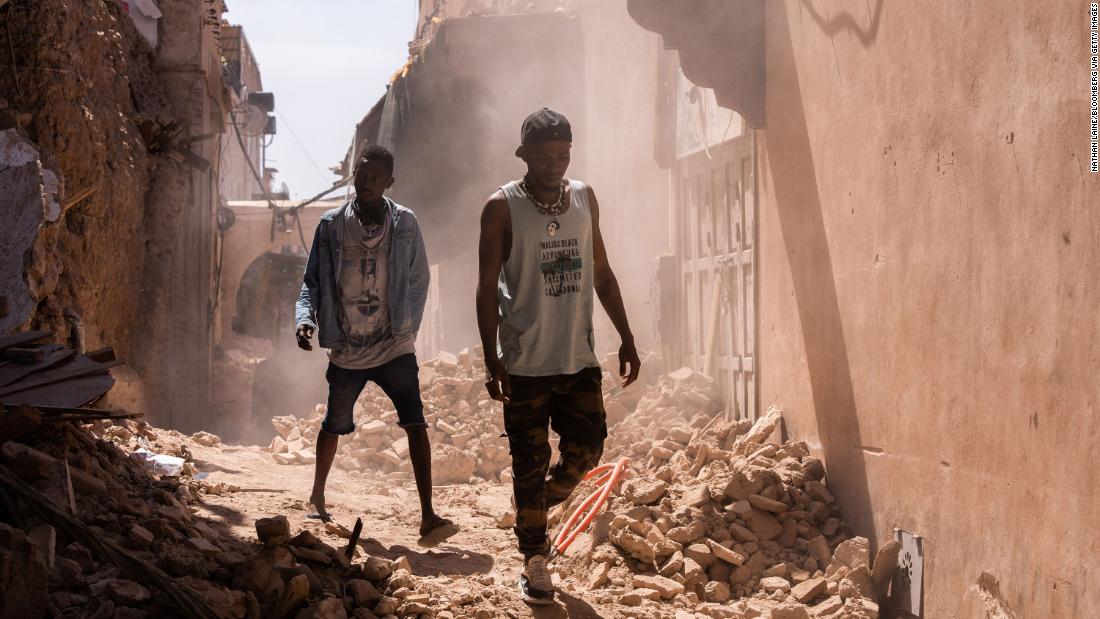 People walk along an alleyway filled with rubble in the Old City district of Marrakech on September 11.