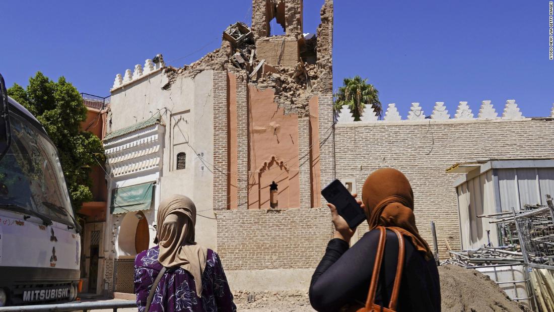 Women look up at the damaged Kharbouch Mosque in Marrakech on September 10.