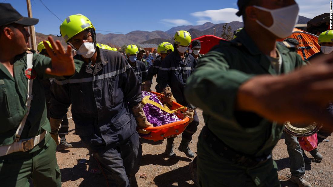 Rescue workers carry a body in Talat N&#39;yaaqoub on September 11.