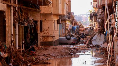 Overturned cars lay among other debris caused by flash floods in Derna, eastern Libya, on September 11, 2023. 