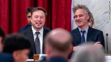 Elon Musk, CEO of X, the company formerly known as Twitter, left, and Alex Karp, CEO of the software firm Palantir Technologies, take their seats as Senate Majority Leader Chuck Schumer, D, N.Y., convenes a closed-door gathering of leading tech CEOs to discuss the priorities and risks surrounding artificial intelligence and how it should be regulated, at the Capitol in Washington, Wednesday, Sept. 13, 2023. 