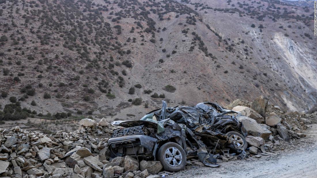A crushed car is buried in rubble by the side of the road between Marrakech and Taroudant on September 16.