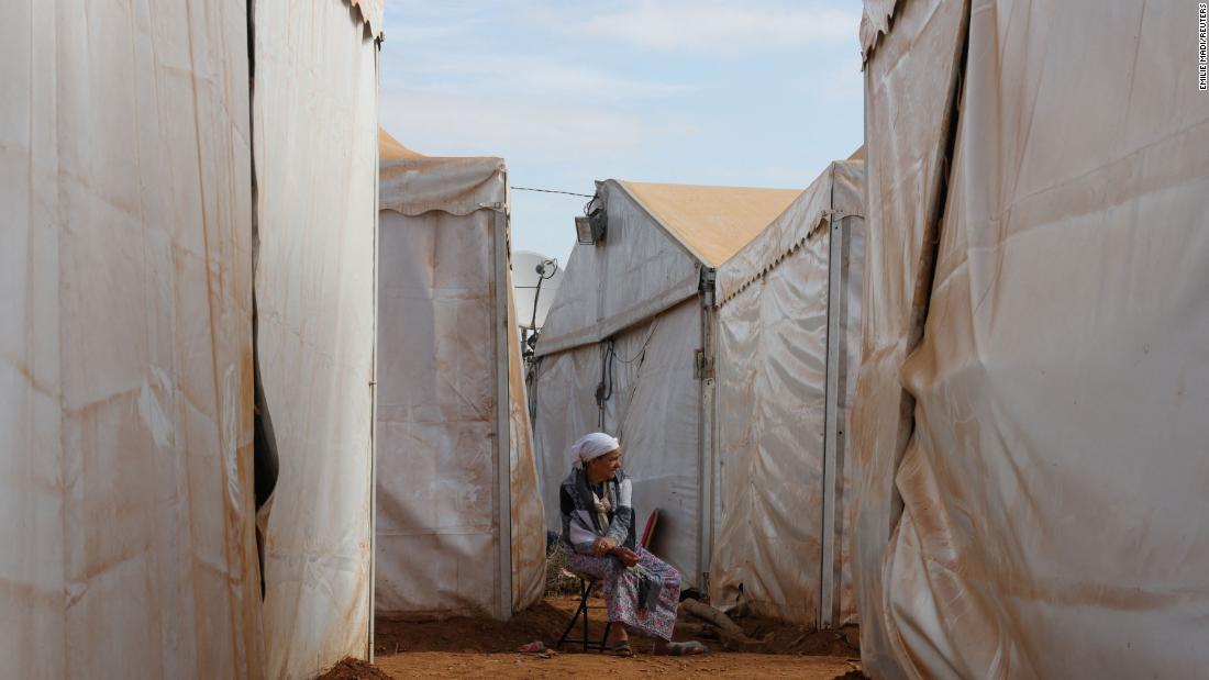 An elderly woman is surrounded by tents at the Regraga camp in Amizmiz, Morocco, on September 17.