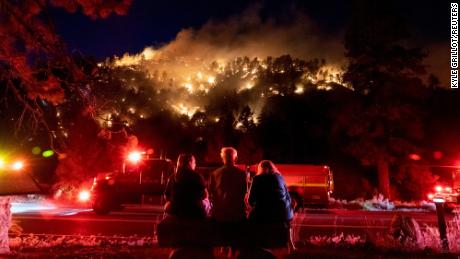 Residents watch part of the Sheep Fire burn through a hillside near their homes in Wrightwood, California, on June 11, 2022. 