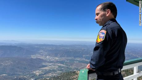 Cal Fire staff chief for fire intelligence Phillip SeLegue stands on a lookout tower in San Diego County. He says AI won&#39;t replace the towers but enhance fire suppression efforts.