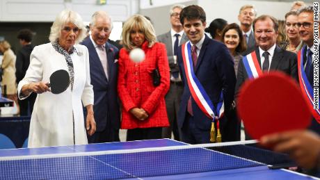 Queen Camilla plays table tennis during a visit to France&#39;s national stadium and venue for next year&#39;s Olympic Games.