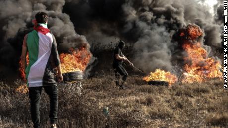 Palestinians set tires on fire during a demonstration against what they say are Israeli &#39;violations&#39; in Jerusalem at the Al Aqsa Mosque on September 22.